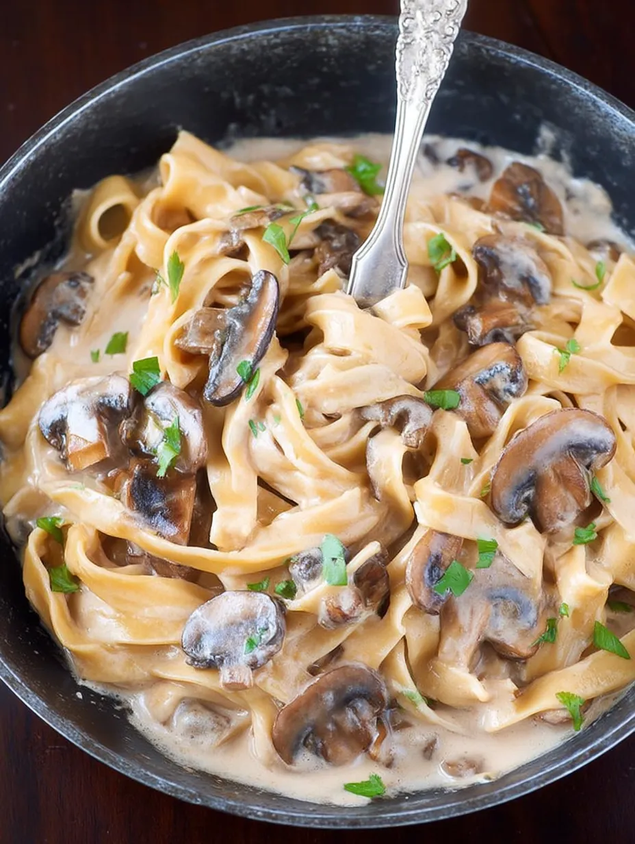 A bowl of mushroom stroganoff with a fork in it.