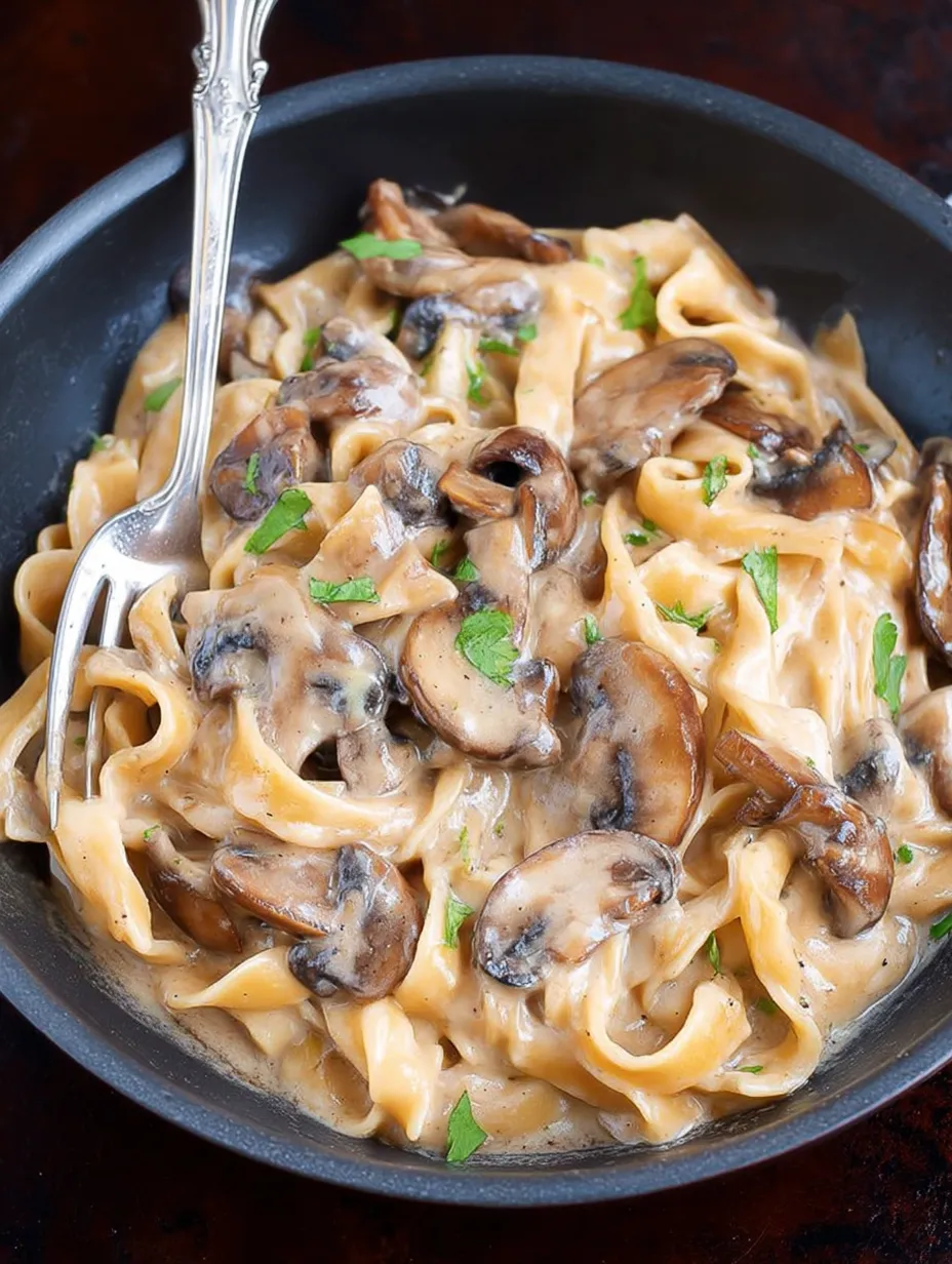 A bowl of mushroom stroganoff with a fork.
